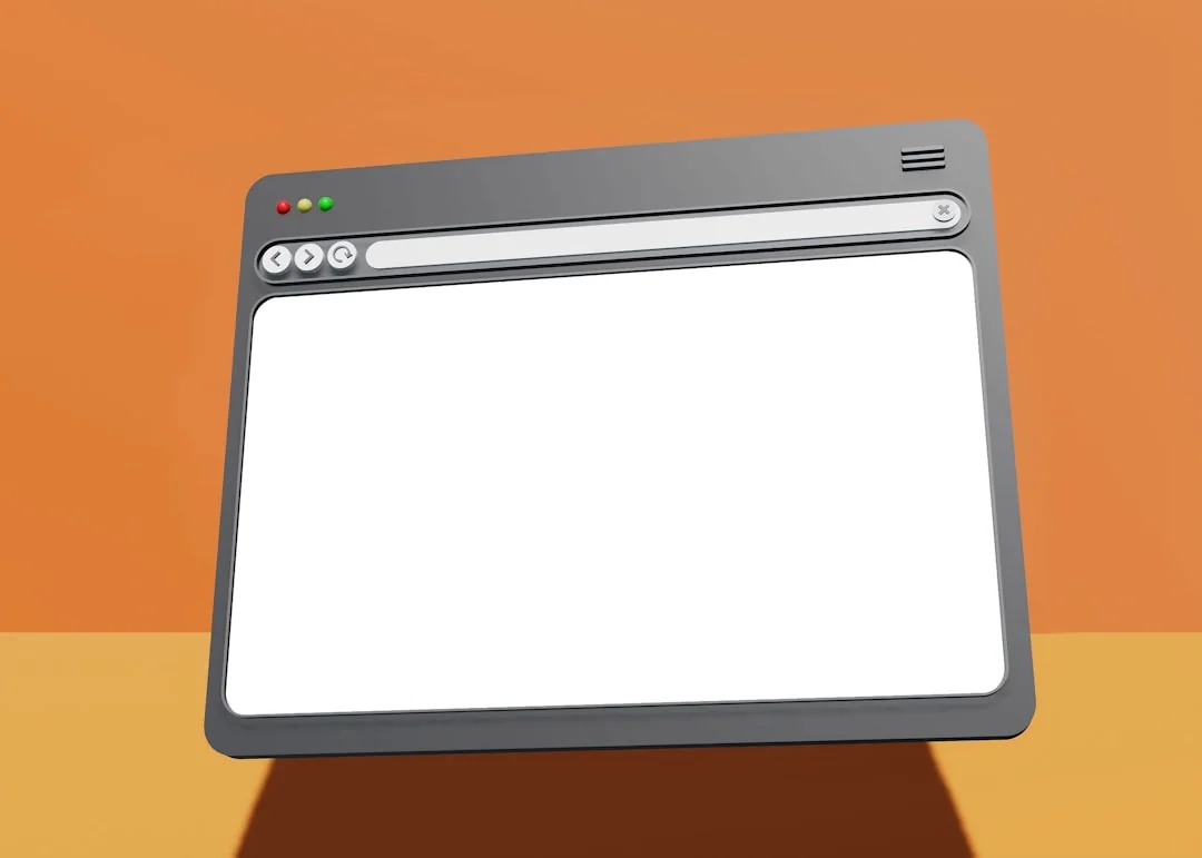 A website wireframe on a macbook screen on an office desk.